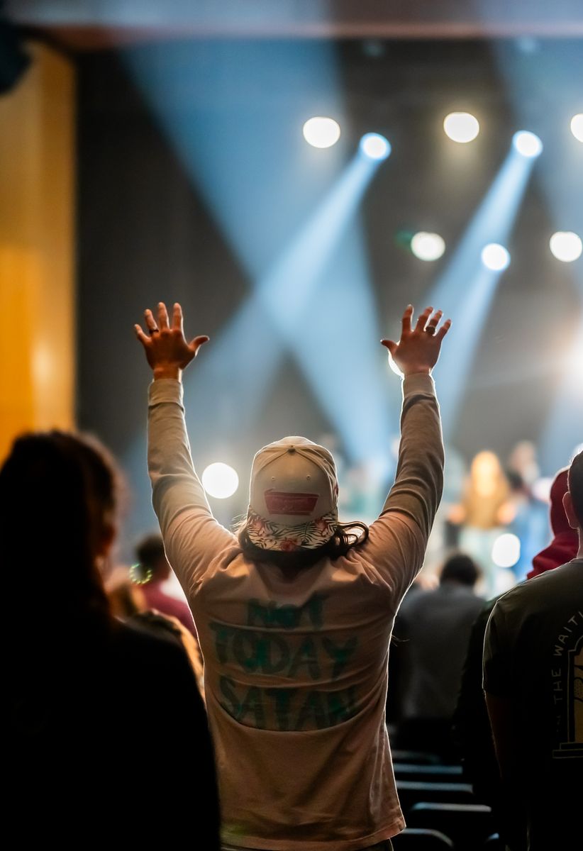A person raising their hands during worship